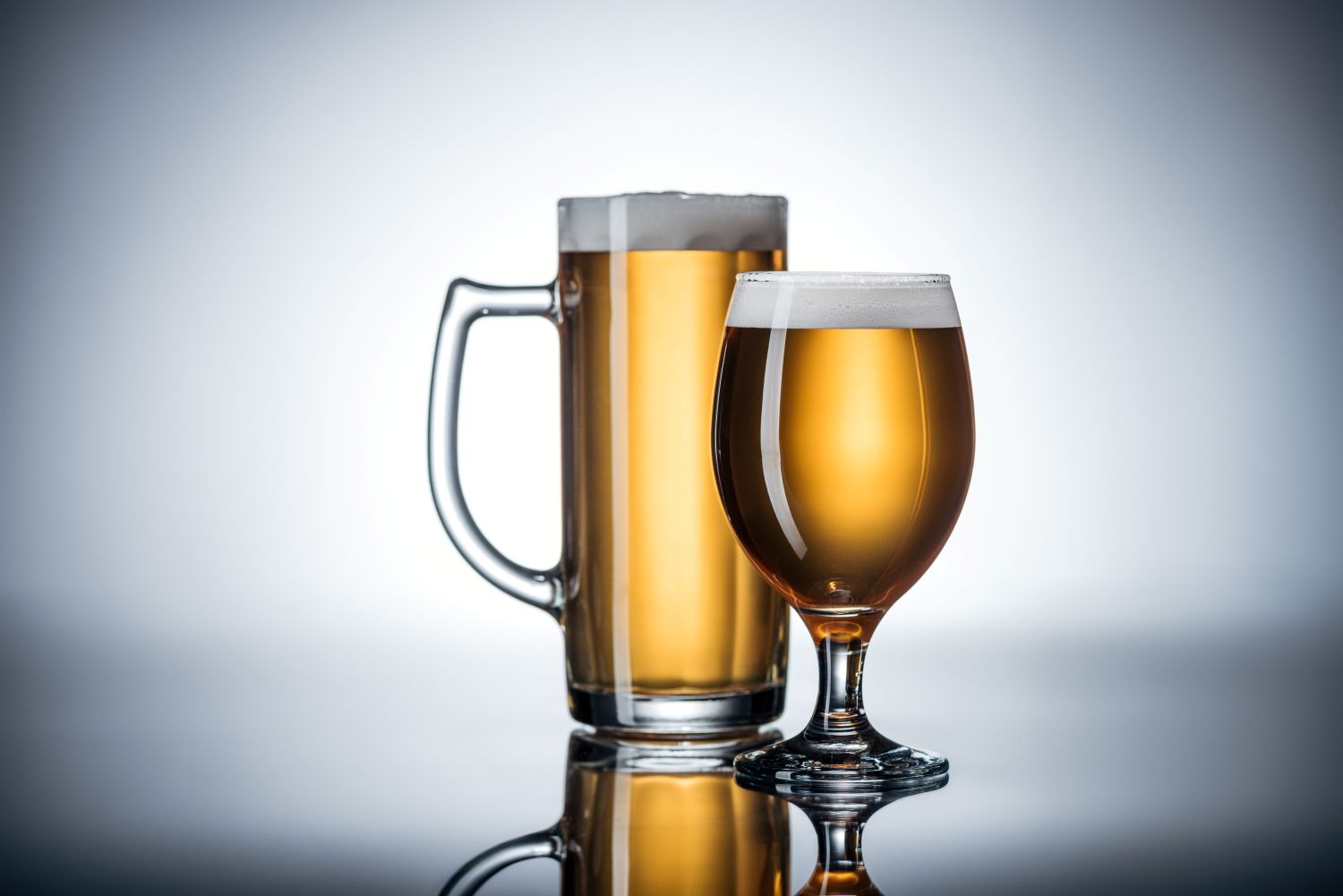 two different beer glasses holding beer